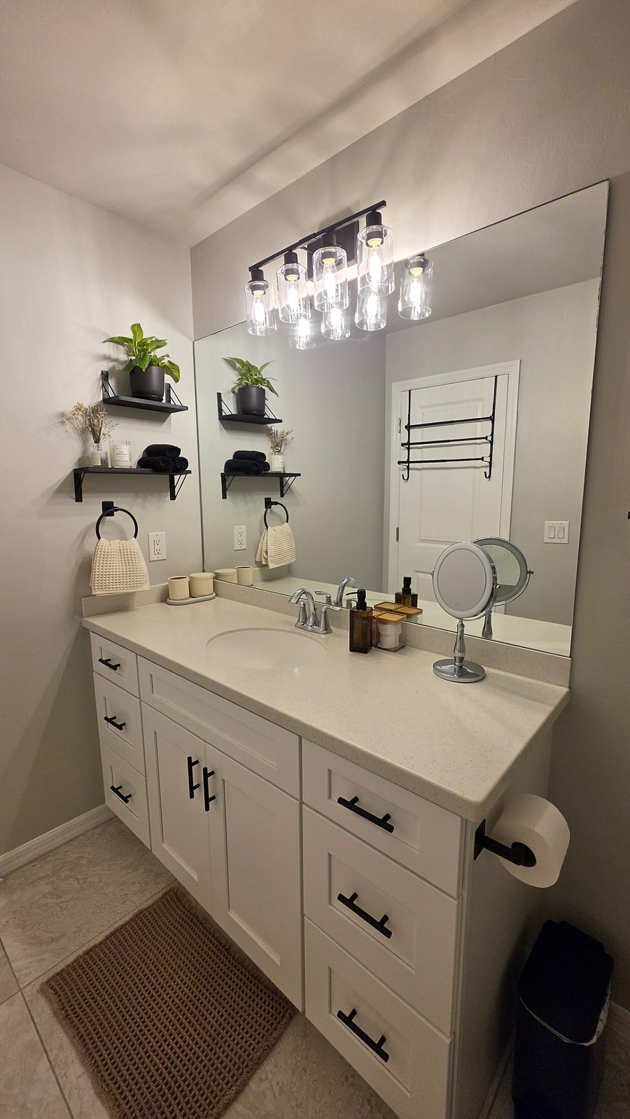 Modern bathroom with a walk-in shower.  Dispenser with shampoo, conditioner, and body wash.  Fresh towels, cotton pads, and swabs provided.  Includes a hair dryer and a makeup mirror for your convenience