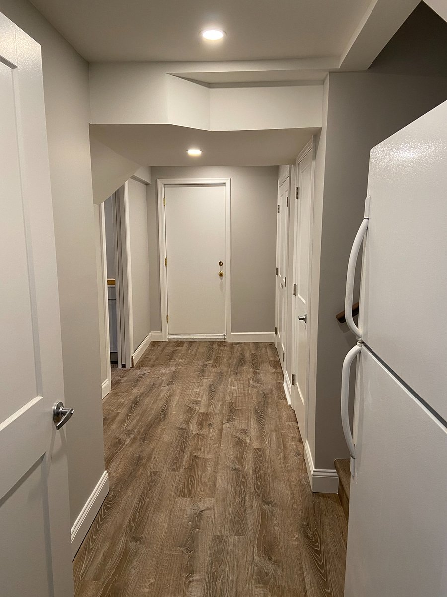 Lower level hallway view from bedroom toward laundry