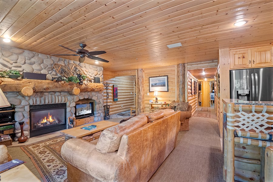 Living room seating area with stone fireplace