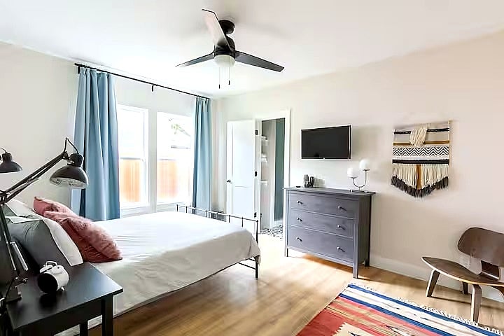 Spacious primary suite with premium bedding, Smart TV, blackout curtains, and plenty of storage for extended stays.