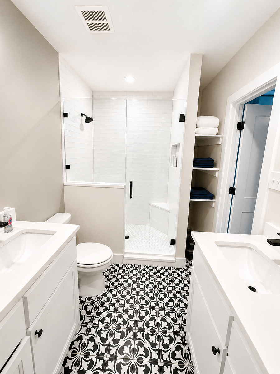 Spotlessly clean bathroom with double sinks, a glass-enclosed shower, and fresh towels provided. Basic toiletries are included for an easy, comfortable stay.