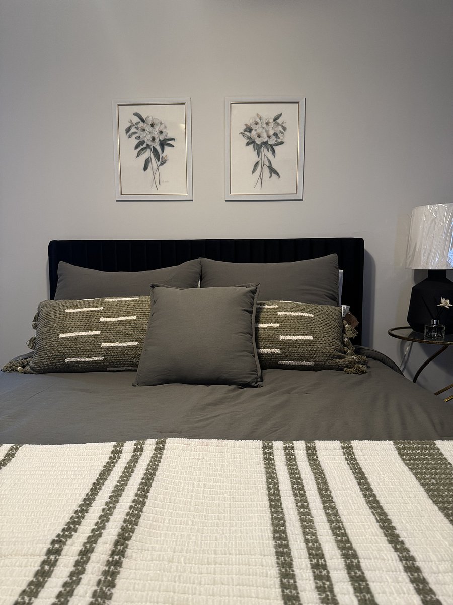 Navy velvet headboard, hotel-quality bedding.