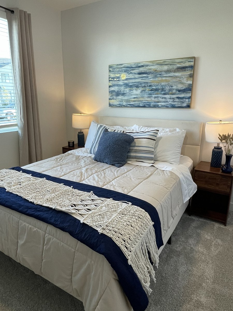 Bedroom two with a queen bed and blackout curtains.