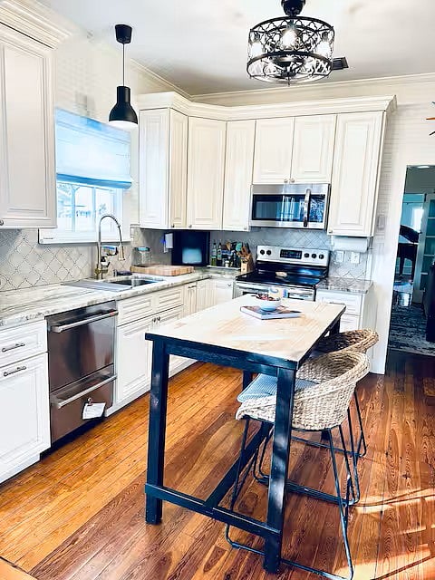 Fully stocked and updated kitchen with marble countertops and a walk-in pantry.