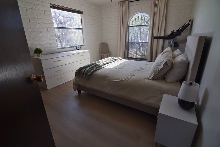 Spacious Guest Bedroom 1 Featuring a Treadmill and Full-Size Dresser