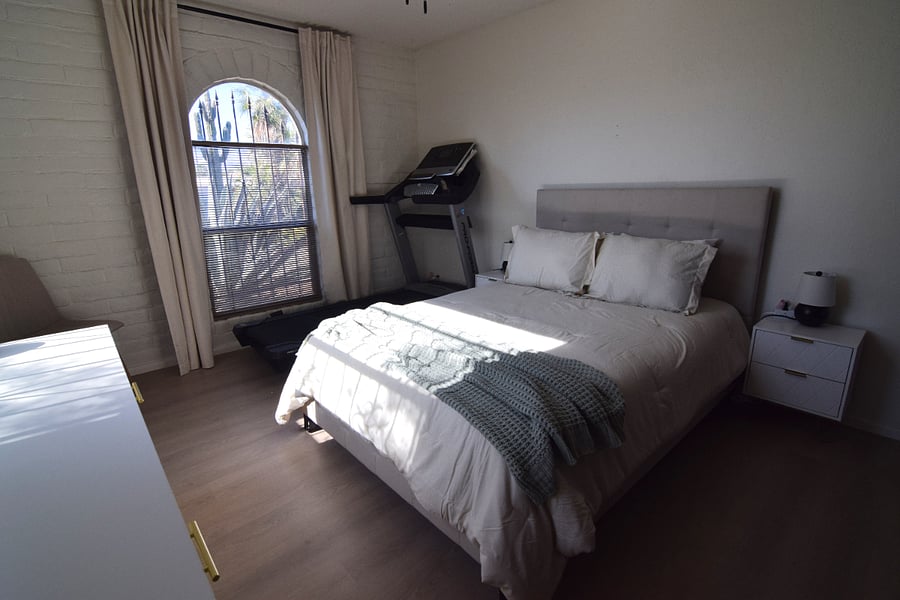 Guest Bedroom 1 Featuring a Treadmill and Full-Size Dresser