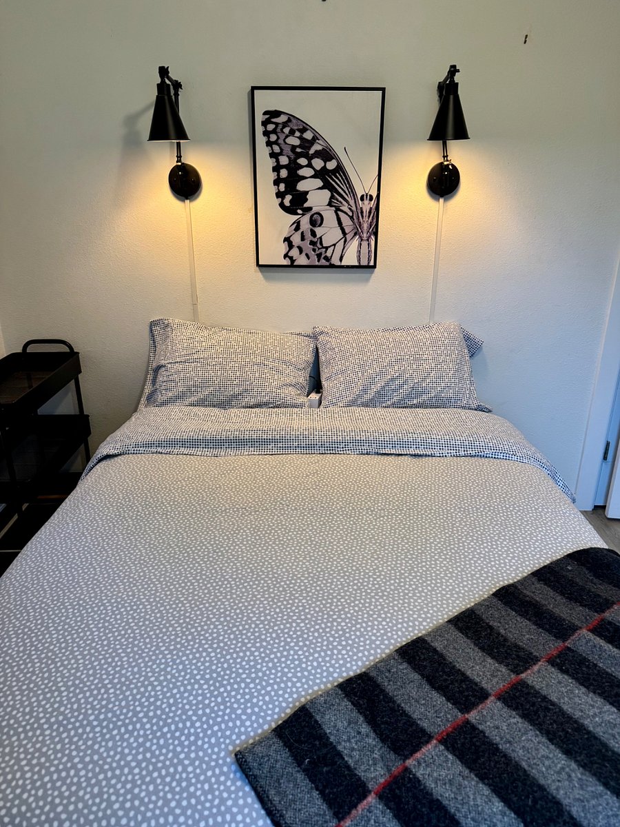 Full size bed, cotton linens and desk in this smaller bedroom looking over the garden.