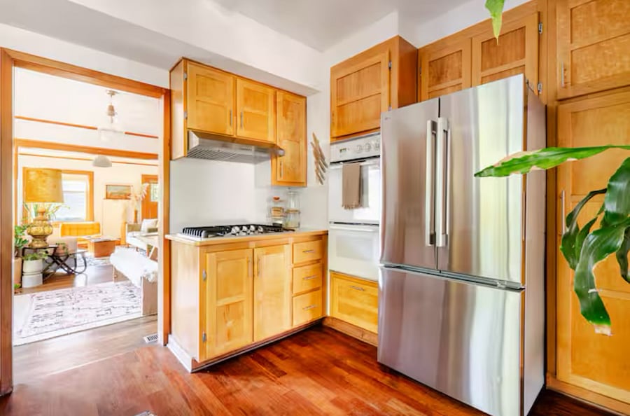 Kitchen has full cooking set up with pots and pans and all kinds of cooking utensils and dishes. Double oven and a microwave and coffee maker.