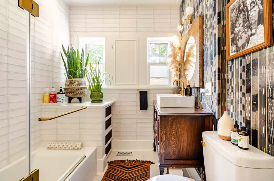 Main floor bathroom with a tub. There is a travel blow dryer and first aid kit