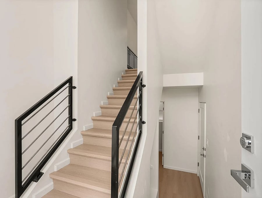 Entryway and view to downstairs to laundry and 3rd guest bathroom.