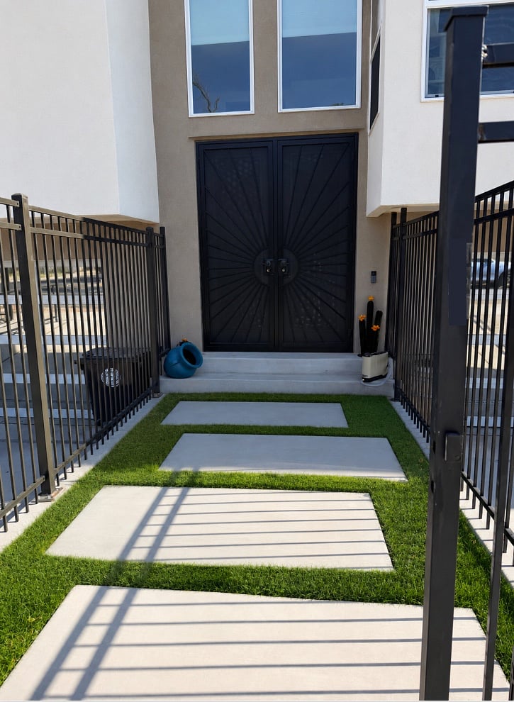 Front Entryway. Not featured are budding ivy plants in the corners of the fencing.