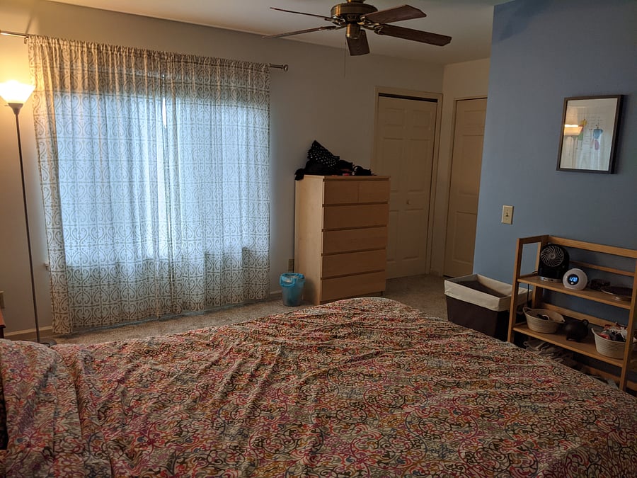 Primary bedroom with extra space where you can access the walk-in closet and a door to the shared bathroom.