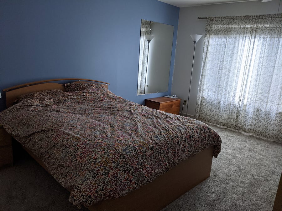 Primary bedroom with king bed. Furnishings will vary as we are in process of moving out and preparing the rental.