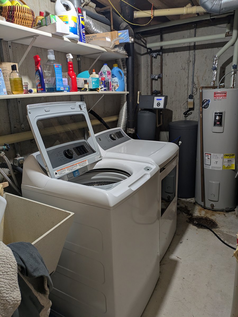 Washer and dryer in basement unfinished area.