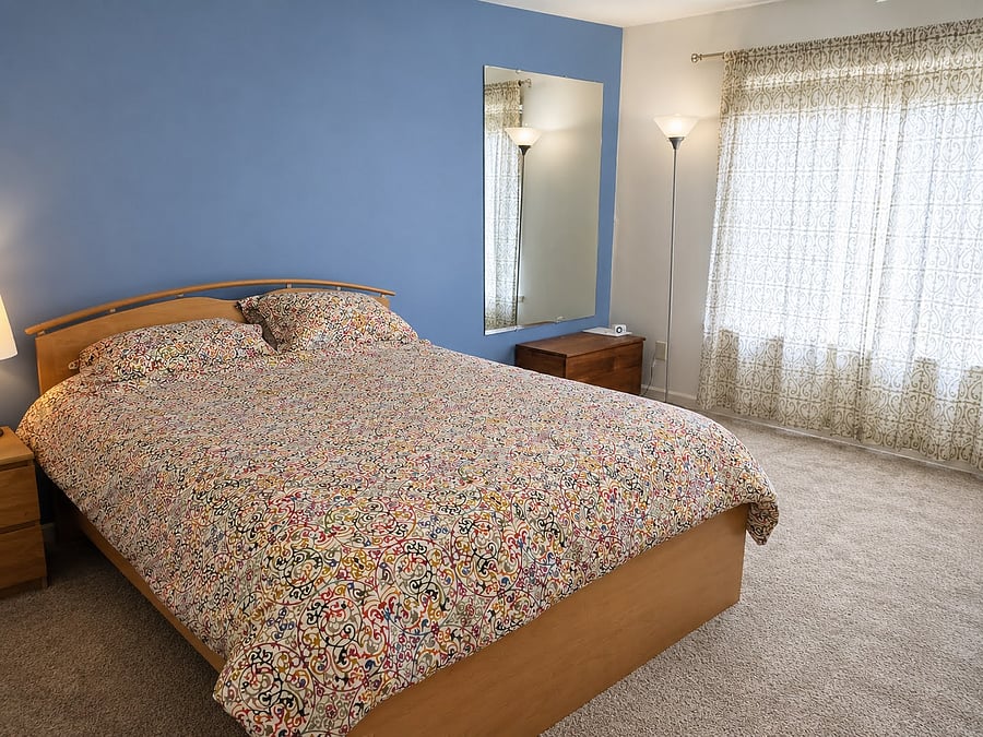 Primary bedroom with king bed. Furnishings will vary as we are in process of moving out and preparing the rental.