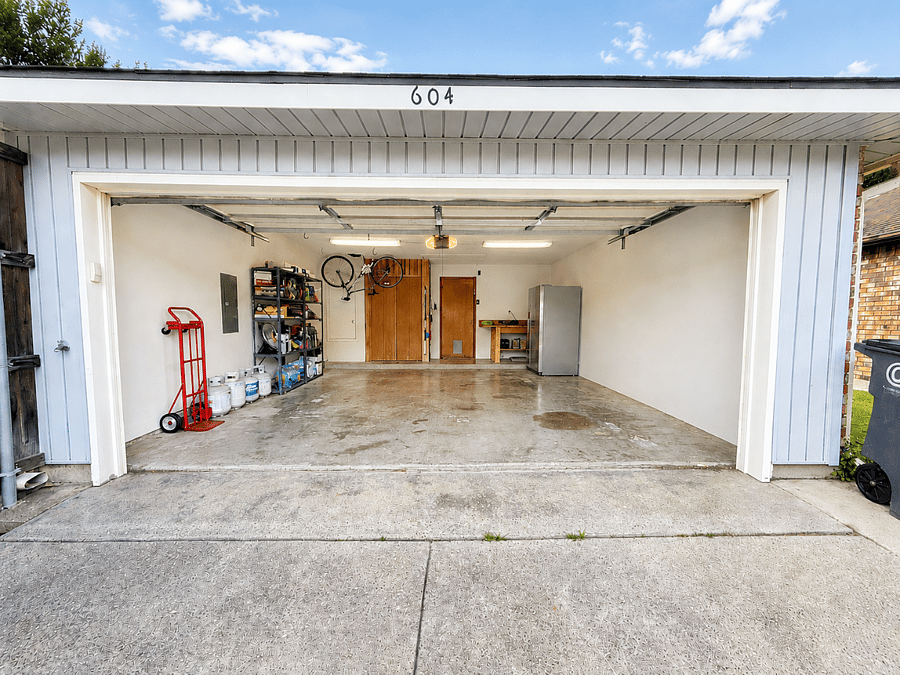 Garage stocked with bike, paper products, cleaning supplies, extra refrigerator, etc..