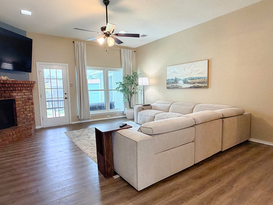 Living Room with reclining couch, smart tv, and fire place