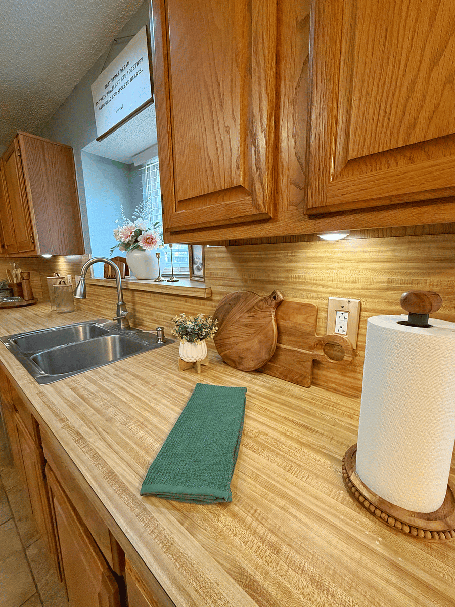 Kitchen with dishwasher, refrigerator, gas stove that includes griddle, microwave, and garbage disposal.