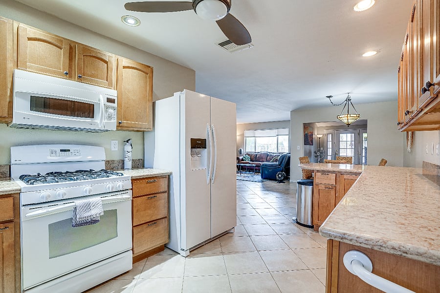 Fully Kitchen, with gas range, microwave, and coffee bar.