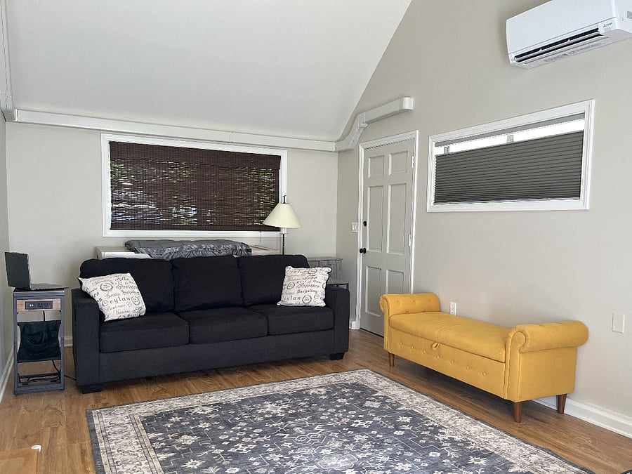 Den with queen Murphy cabinet bed and smart TV.