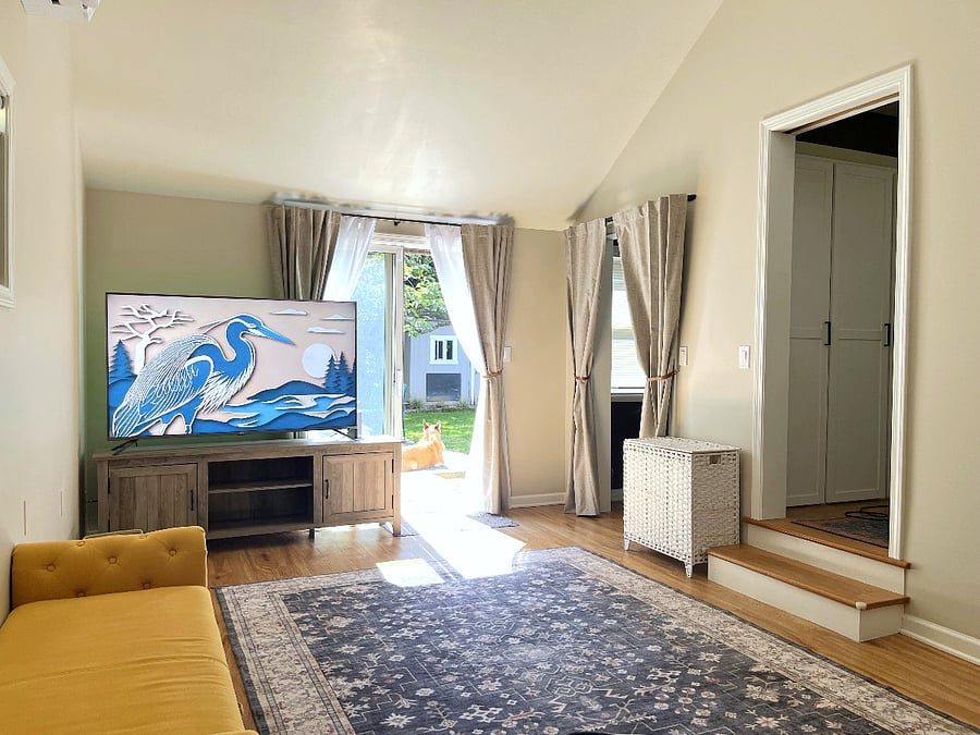 Den with queen Murphy cabinet bed and smart TV.