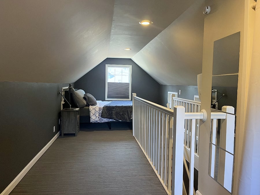 Private upstairs with queen bed and workspace.