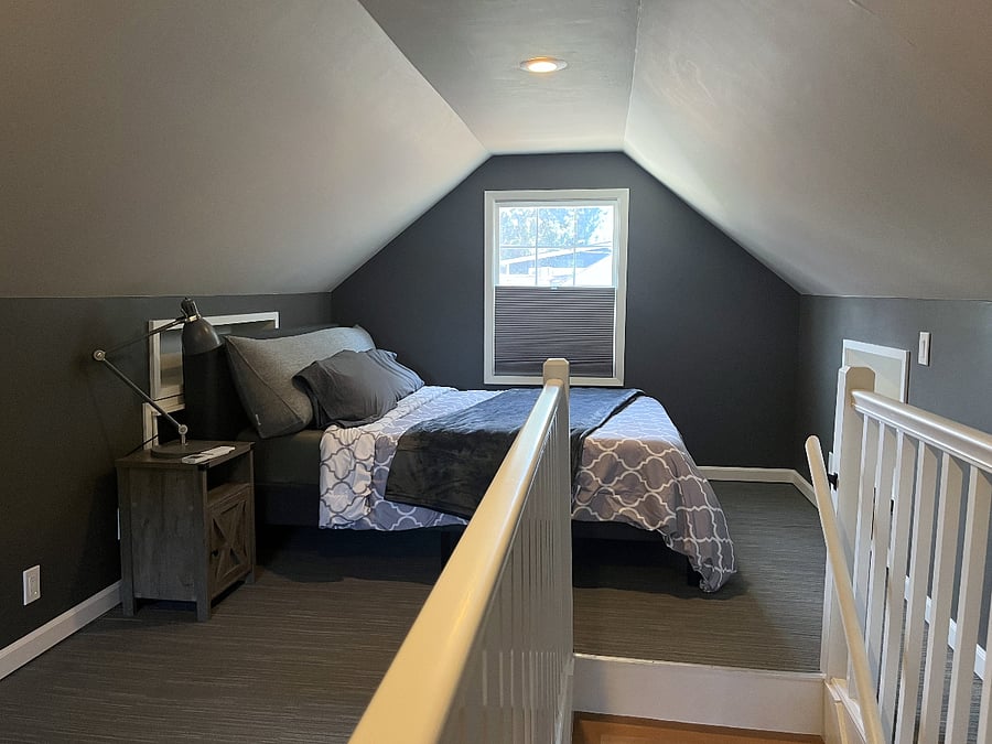 Private upstairs with queen bed and workspace.