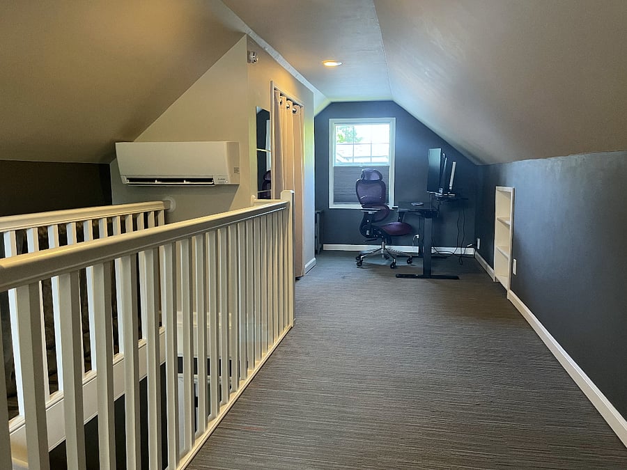 Private upstairs with queen bed and workspace.