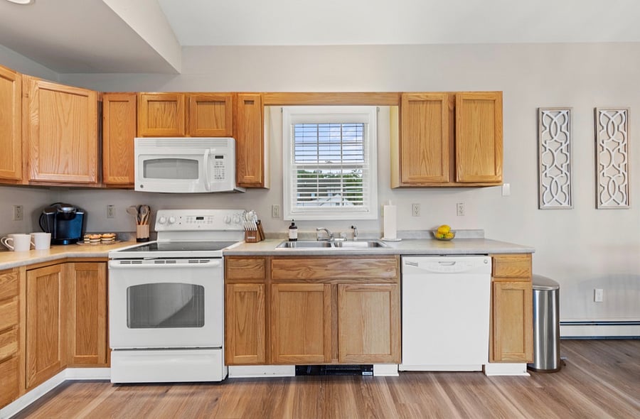 Please note: Since this photo was taken, the kitchen has been beautifully updated with white cabinets and brand-new stainless steel appliances.