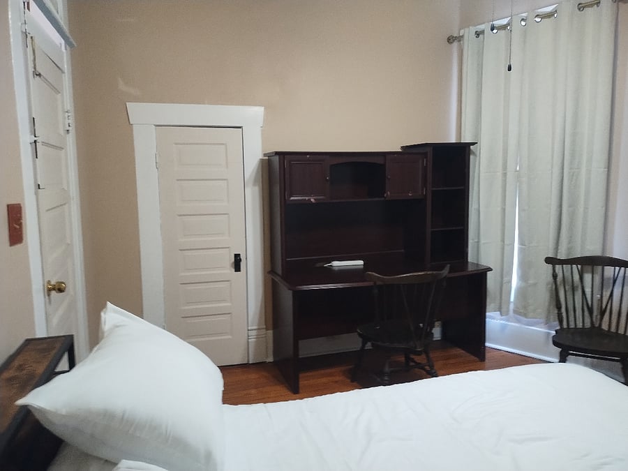 Queen size bedroom has a full size desk.
