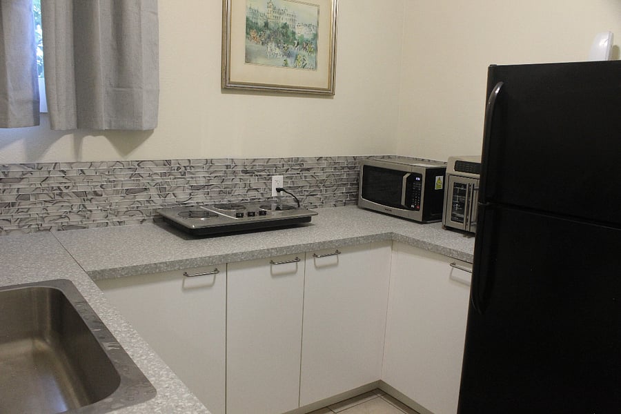 Kitchen has cooktop, microwave and airfryer oven.