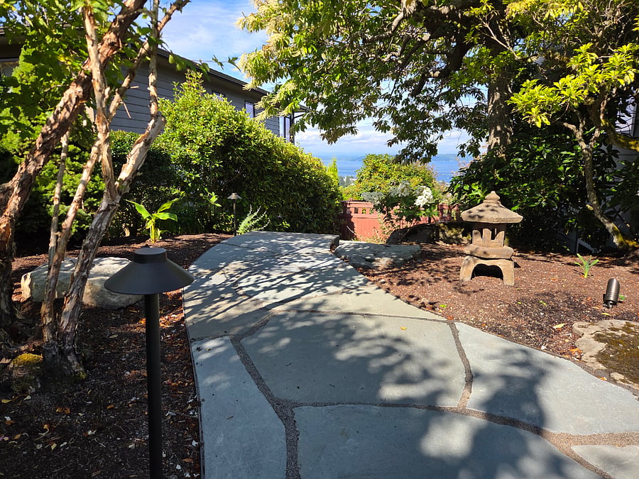 Stroll through designer-garden towards water view.