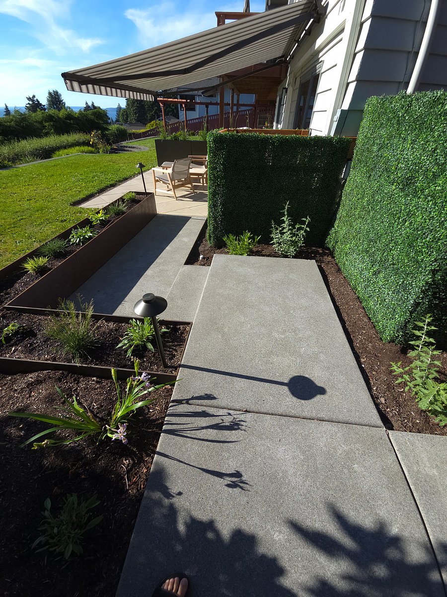 Concrete path and a few steps along raised garden bed guides you home.