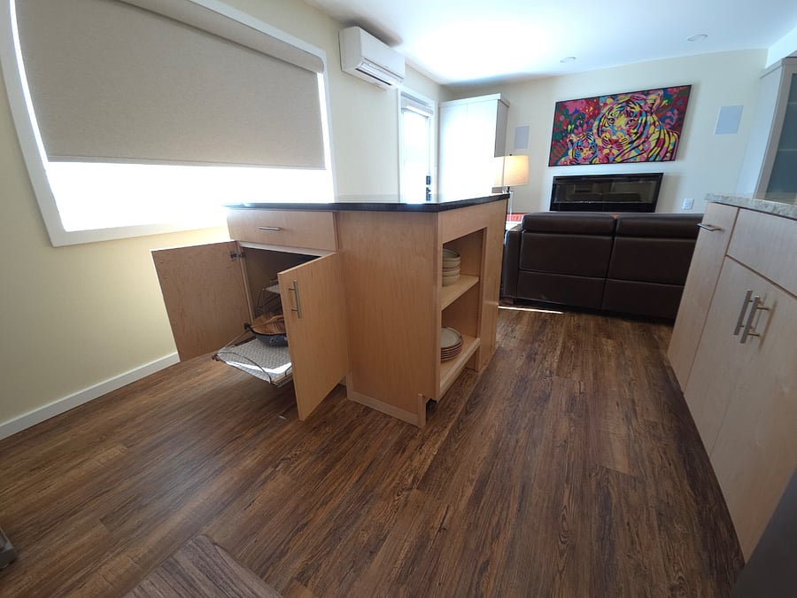 Island provides storage for cookware, a utensils drawer, and shelving. Island is on coasters and can be moved/turned