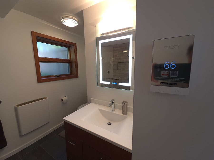 Thin wall heater and heated tile floor provides warmth in the winter. Two-sided medicine cabinet has de-fogging mirror.