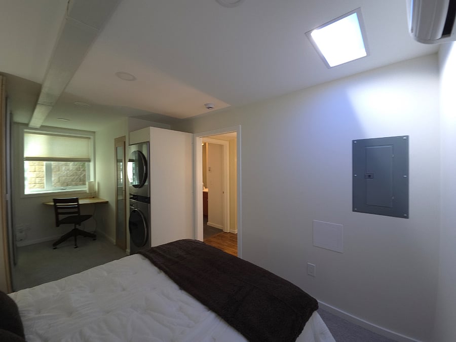 Faux skylight with adjustable settings makes it easy to forget this is a daylight basement.