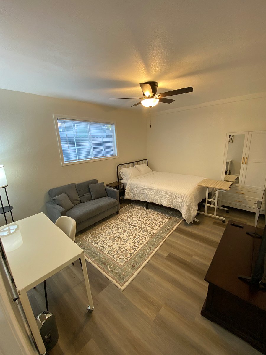 2nd bedroom with queen sized bed, couch, desk and TV