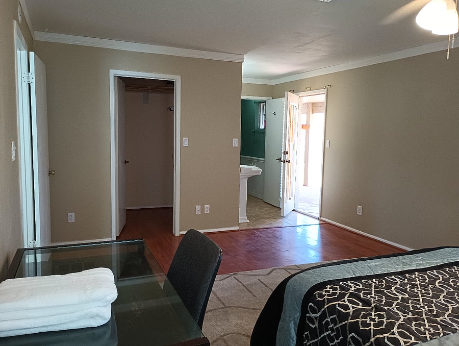 Master bedroom, private bathroom, larger closet, door to backyard