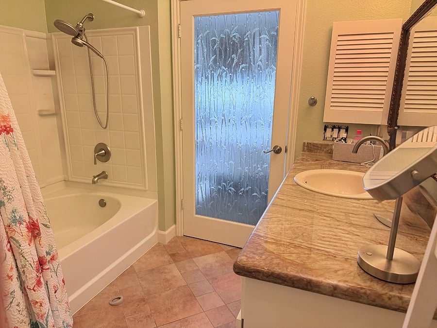 Private primary bathroom with tub-and-shower combination.