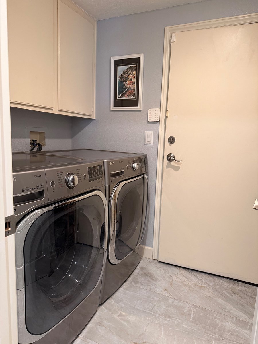 Full-size washer and dryer with direct access to the private garage.