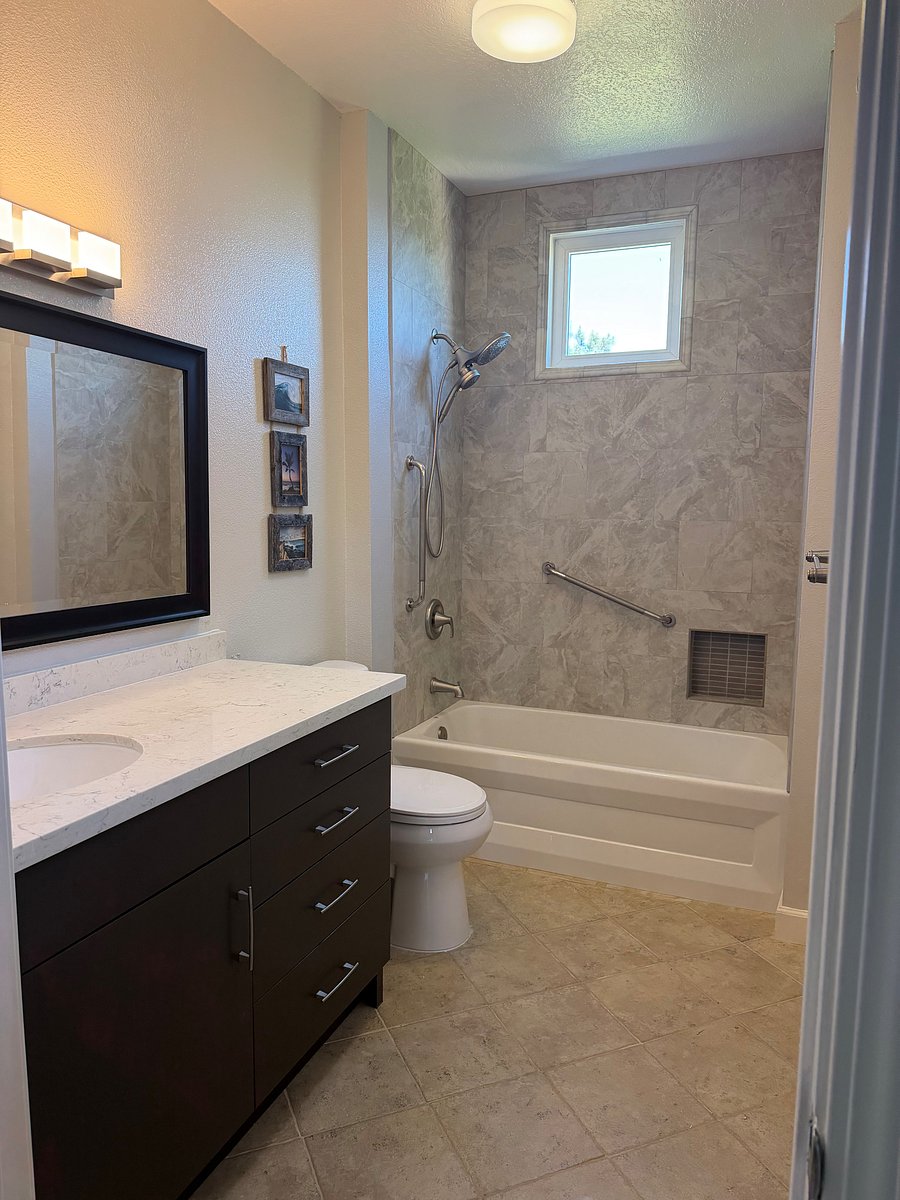 Newly remodeled private bath with a new shower and granite countertop