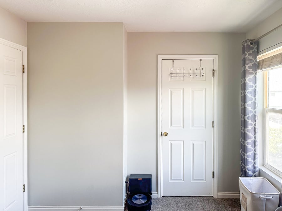 Master bedroom features a Roomba vacuum with self-emptying bin.