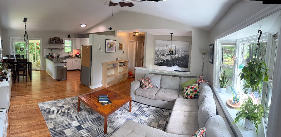 Living area from the front corner, wrapping around through dining area and kitchen