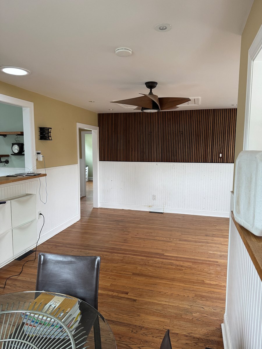 Living room - picture taken from dining room area. This slat wall will have a tv console and smart tv 