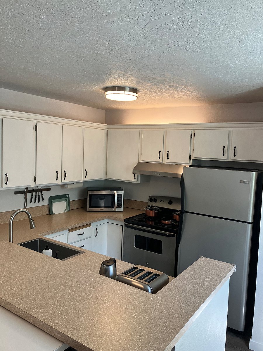 Kitchen with stainless steel appliances: refrigerator, stove, dishwasher, toaster, electric kettle
