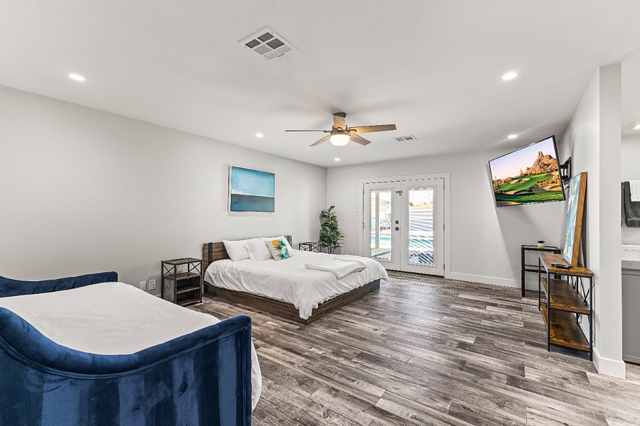 Master Suite, King Bed and Chaisse Lounge that has two twin beds. 65 inch smart TV