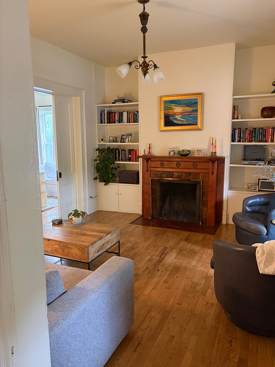 Front room featuring original fireplace and pocket doors
