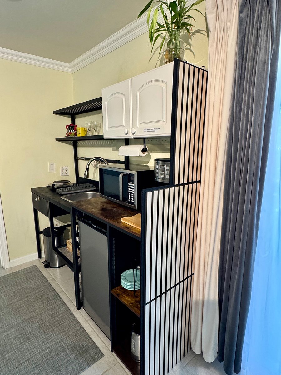 Well-equipped kitchenette with cooktop, microwave, fridge/freezer, coffee maker, toaster, kettle, dishware