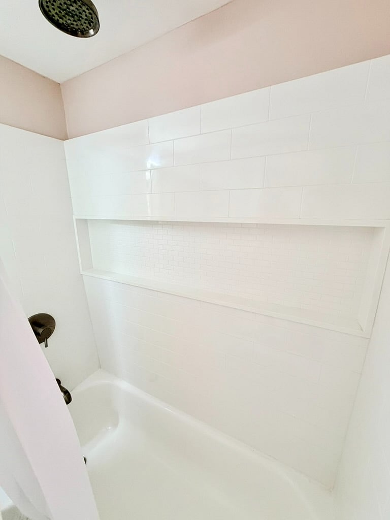 Rainfall shower head and built-in shower shelf.