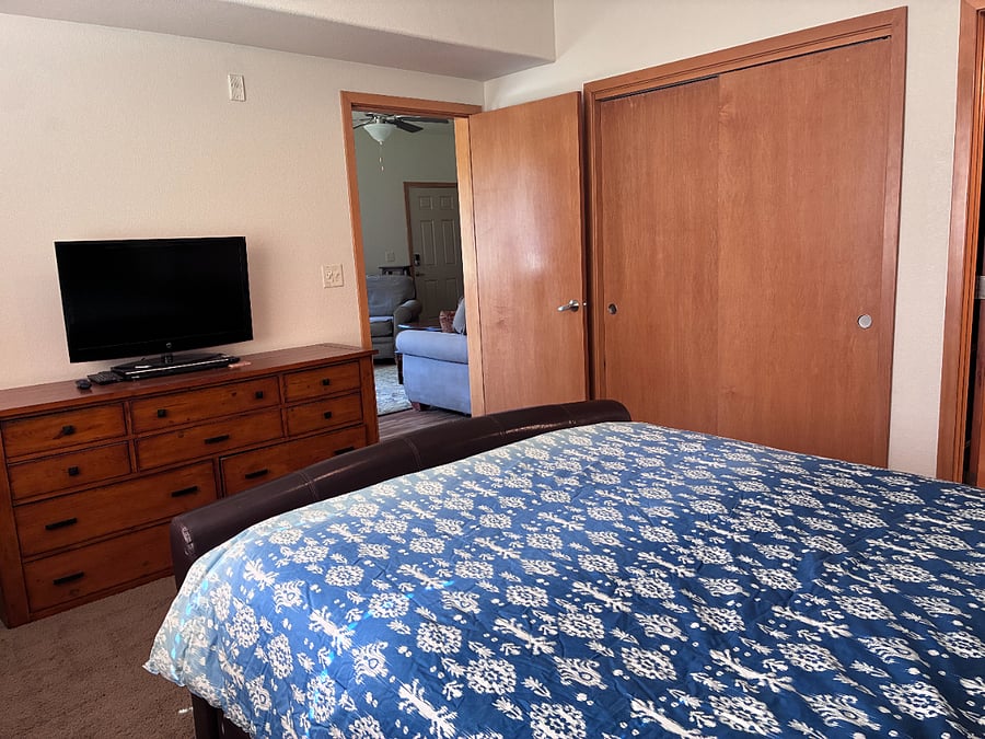Master bedroom has an additional TV and larger dresser with a full-sized closet.